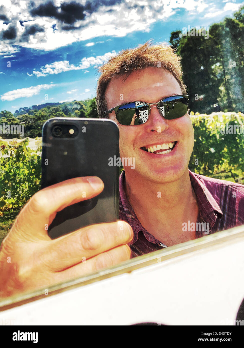 Middle aged man selfie in a mirror - Smartphone Captured Stock Image