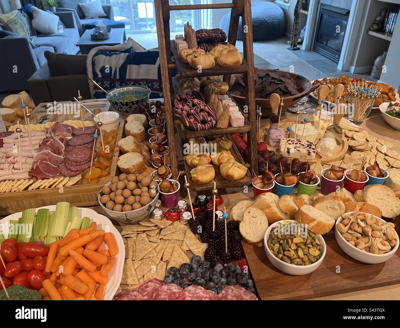 A gourmet food spread for a home party with charcuterie board and