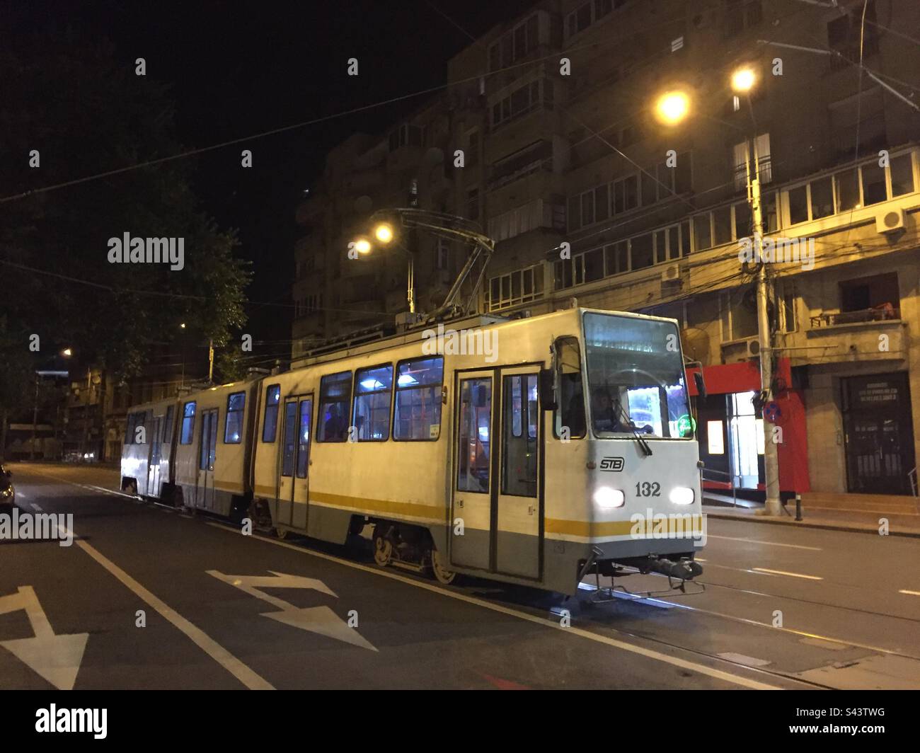 Bucharest, Romania. Street scene with passing tram. Public transport in Bucharest. - Smartphone Captured Stock Image