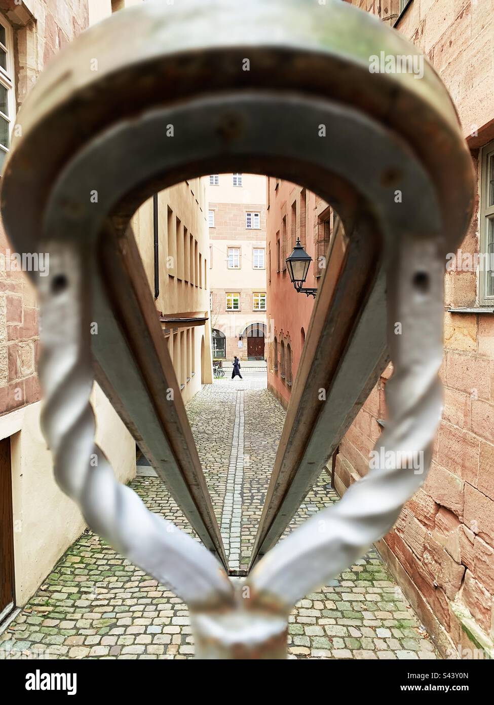 Silhouette of a tiny human walking in old town - Smartphone Captured Stock Image