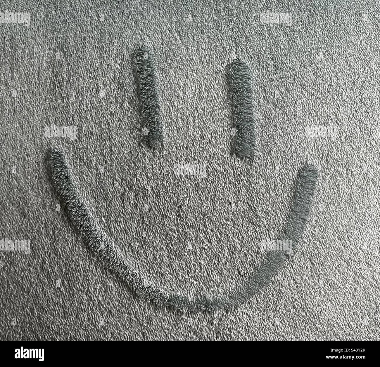 Smiley face on soft blue fabric Stock Photo