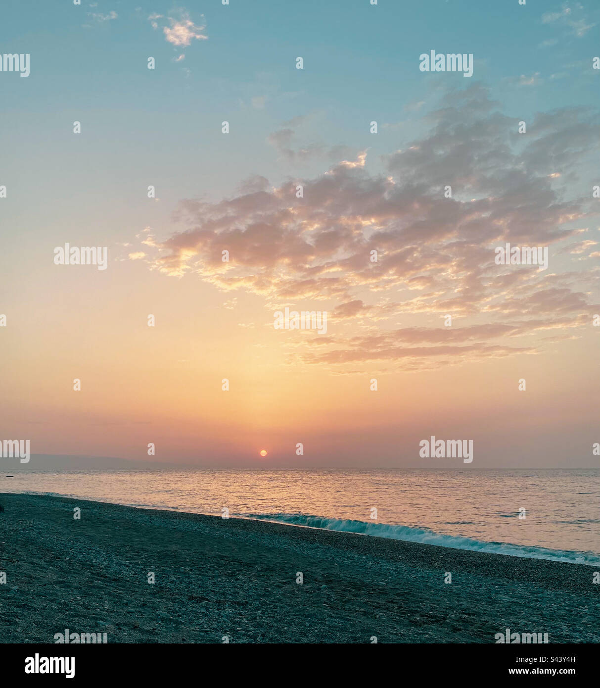 A beautiful sun sets on a beach in Sicily, Italy - Smartphone Captured Stock Image