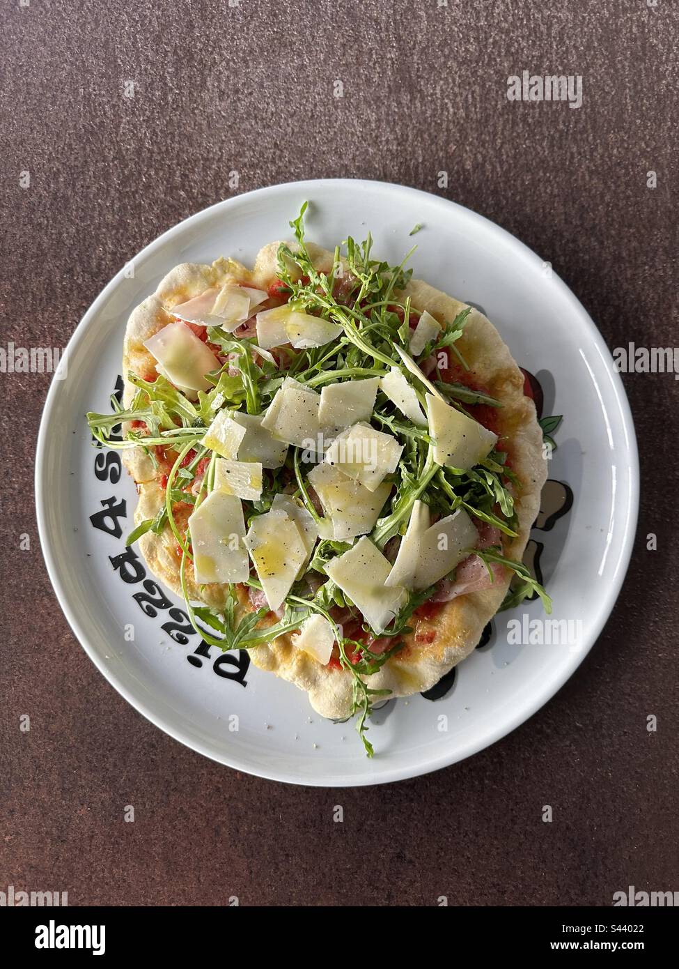 Homemade pizza with prosciutto, arugula and Parmesan cheese Stock Photo