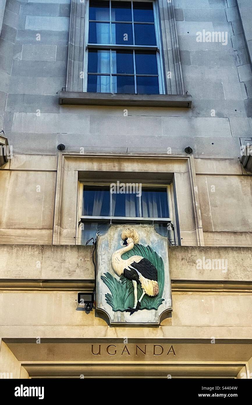 Plaque above Uganda House in central London near Trafalgar Square. The grey crowned crane is fabled for its gentle nature and was also the military badge of Ugandan soldiers during British rule. - Smartphone Captured Stock Image