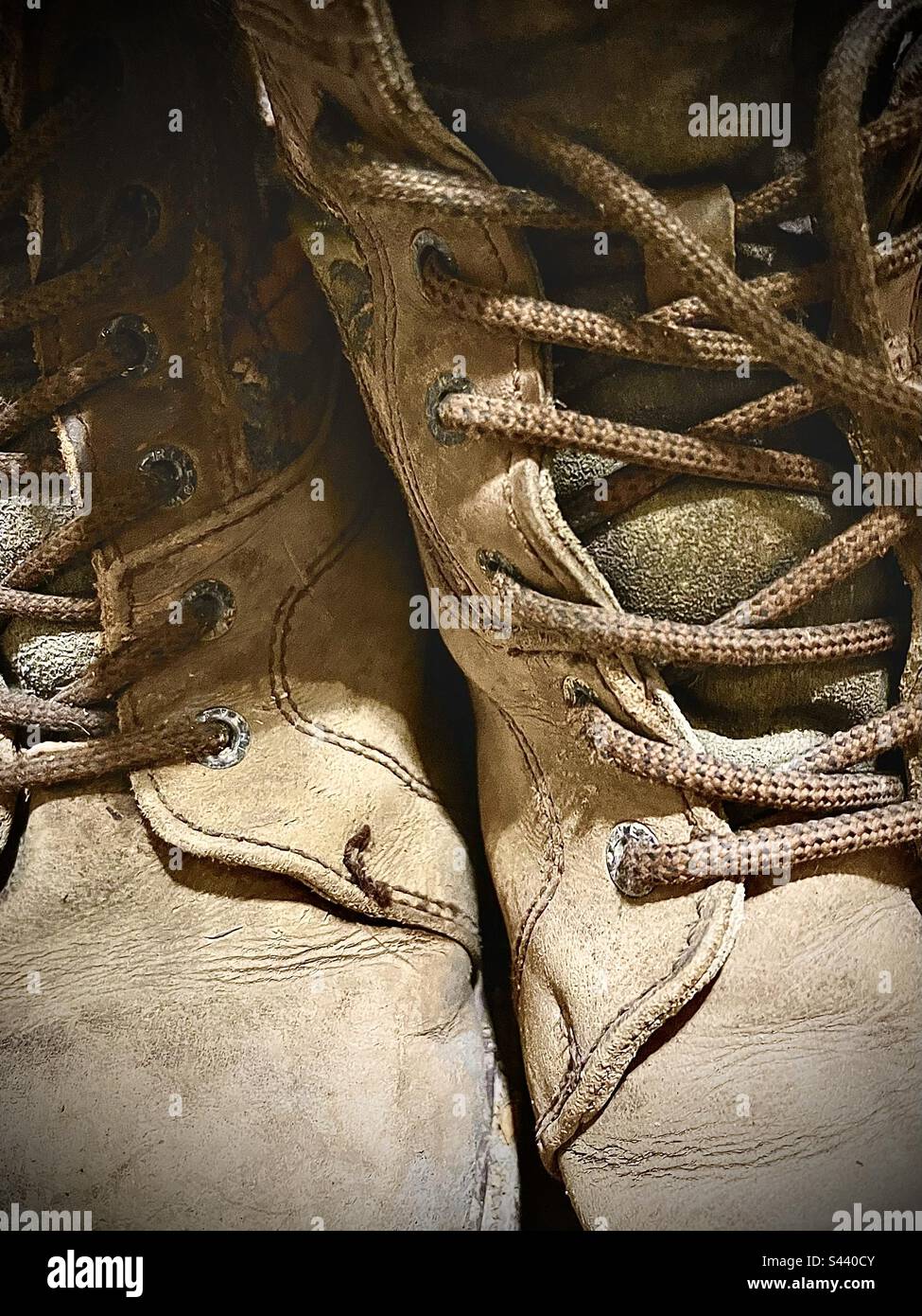 Closeup of rugged worn brown work boots. Fills entire frame.. Stock Photo