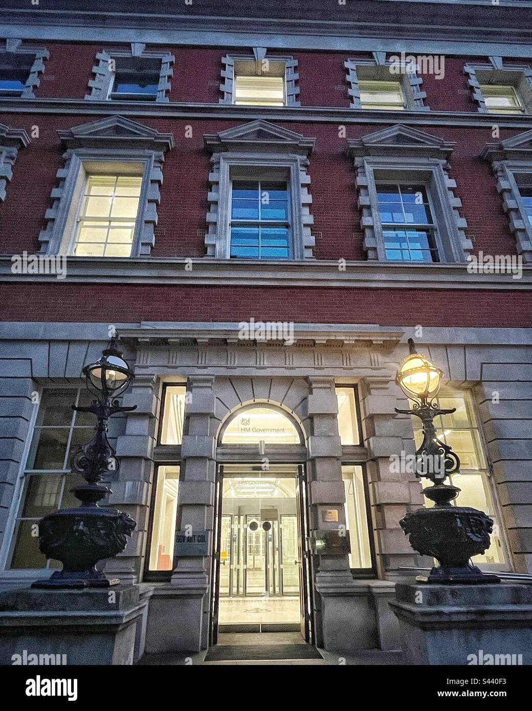 Admiralty House in London was designed by Samuel Pepys Cockerell, a protégé of Sir Robert Taylor, and opened in 1788. Grade I Listed Building and HM Government Building seen at night, lamps on - Smartphone Captured Stock Image