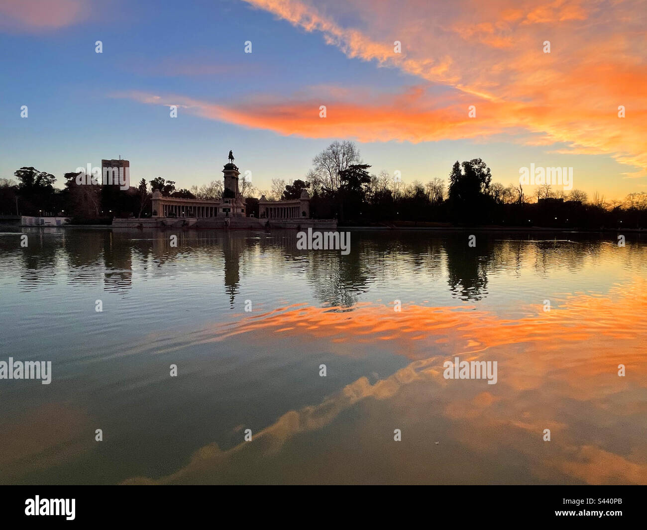Dawn sky and its reflection on the pond. El Retiro park, Madrid, Spain. Stock Photo