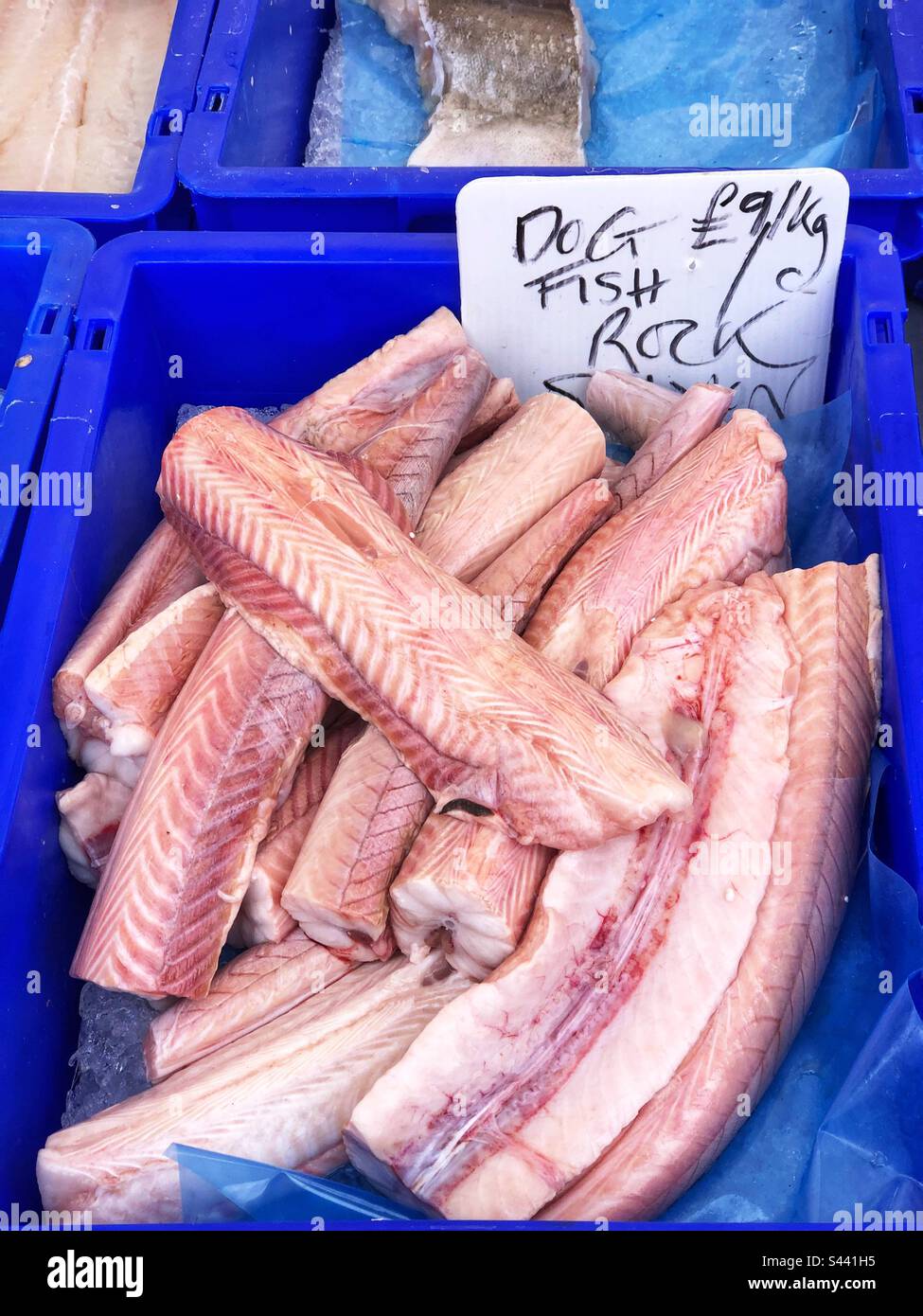 Dogfish or Rock salmon fillets priced up for sale at local farmers market - Smartphone Captured Stock Image