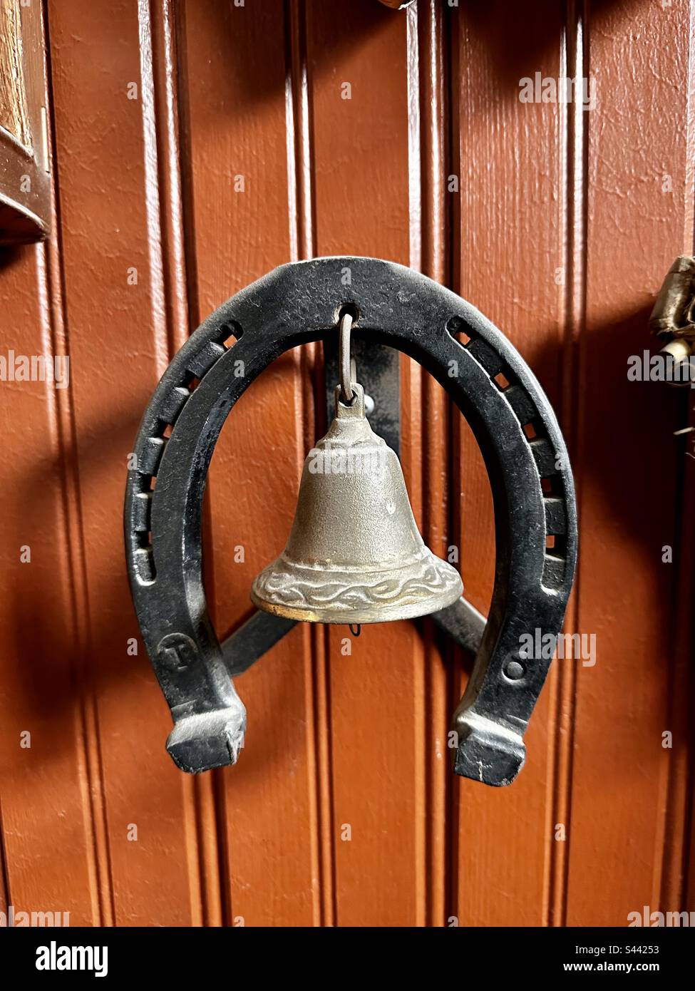 Small bell decoration on wall - Smartphone Captured Stock Image