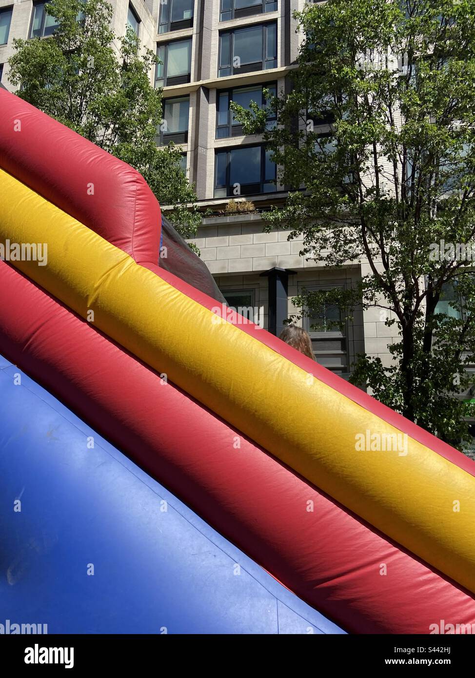 Blue red and yellow rubber slide on upper east side New York Stock Photo