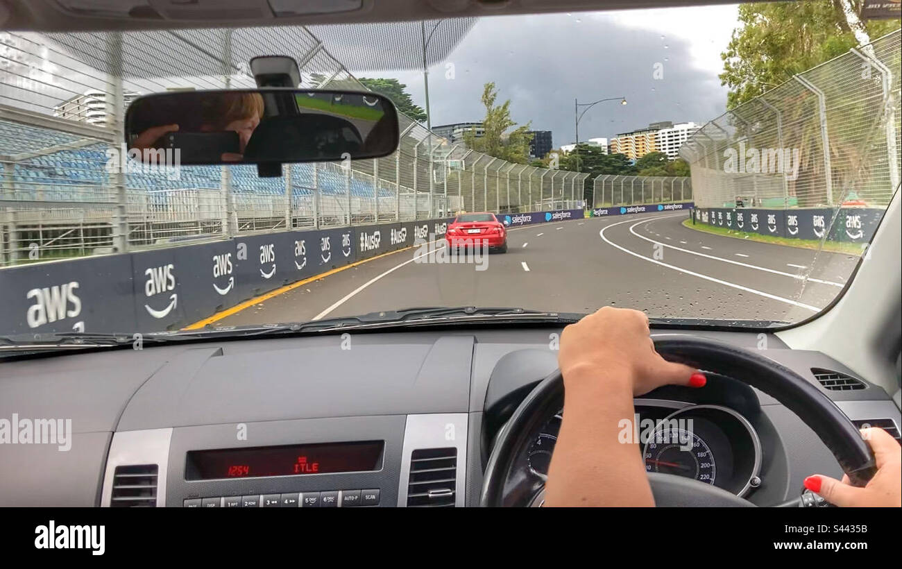Woman driving on Albert Park Grand Prix Circuit Melbourne Victoria Australia - Smartphone Captured Stock Image