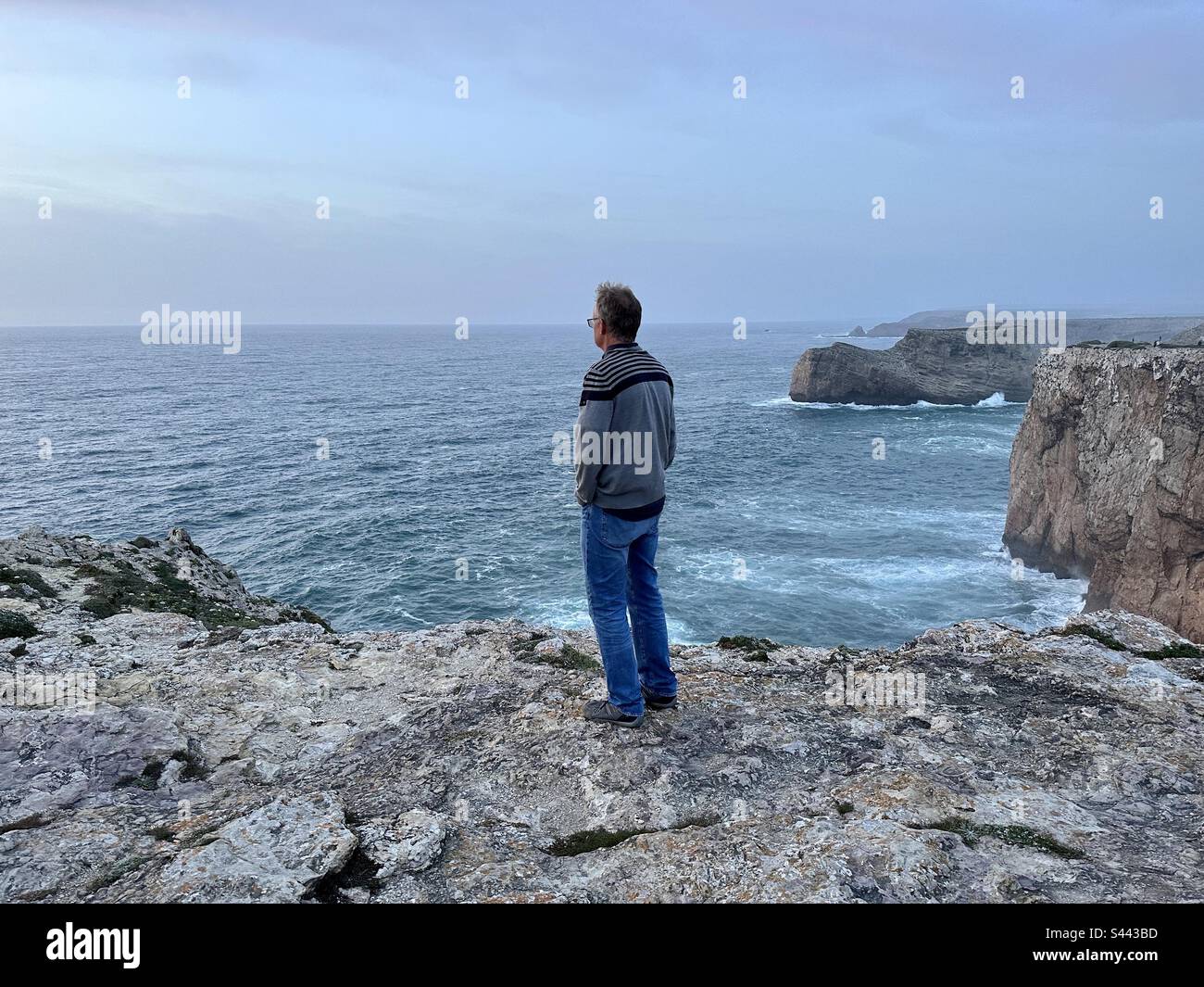 Man looking at the view from Cape Vincent near Sagres, Portugal - Smartphone Captured Stock Image