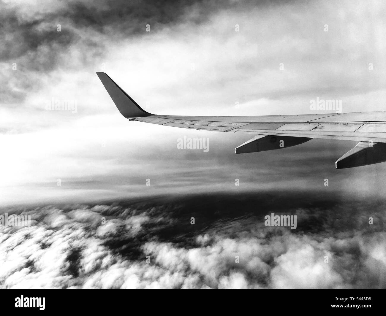 Airplane wing image above the atlantic ocean, in a cloudy sky day - Smartphone Captured Stock Image