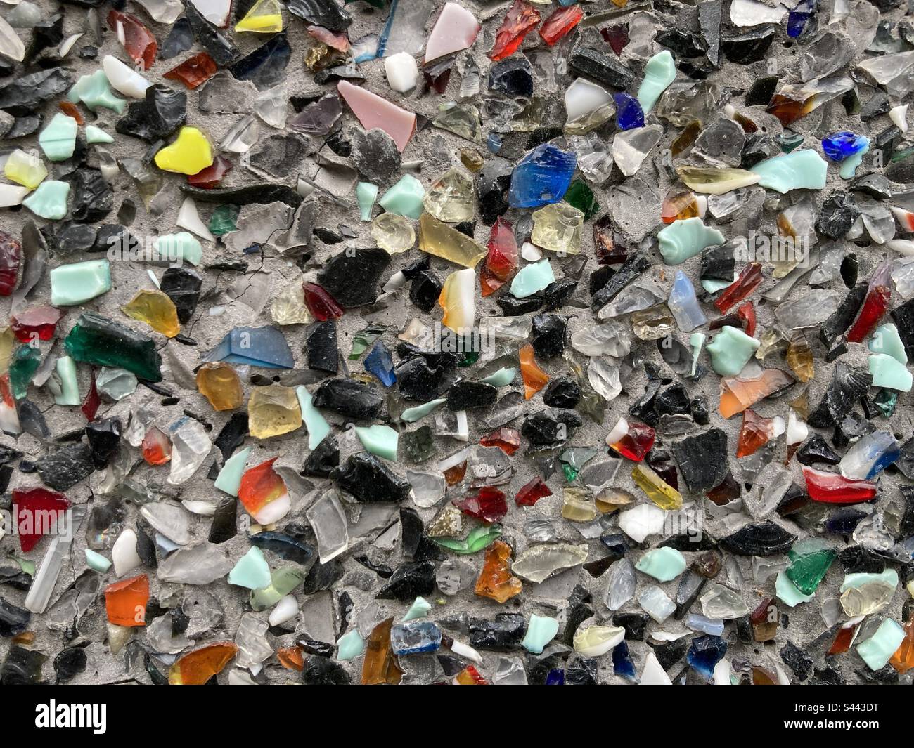 small colorful glass shards on a gray surface - Smartphone Captured Stock Image