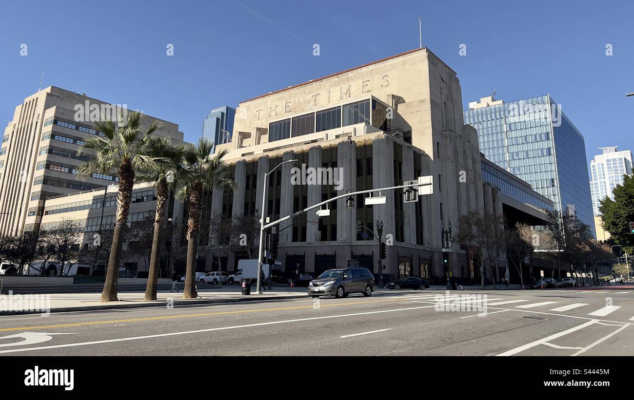 LOS ANGELES, CA, DEC 2022: wide view Los Angeles Times Building with LA Police Department headquarters behind it in Civic Center area, Downtown. Palm trees on corner in foreground - Smartphone Captured Stock Image