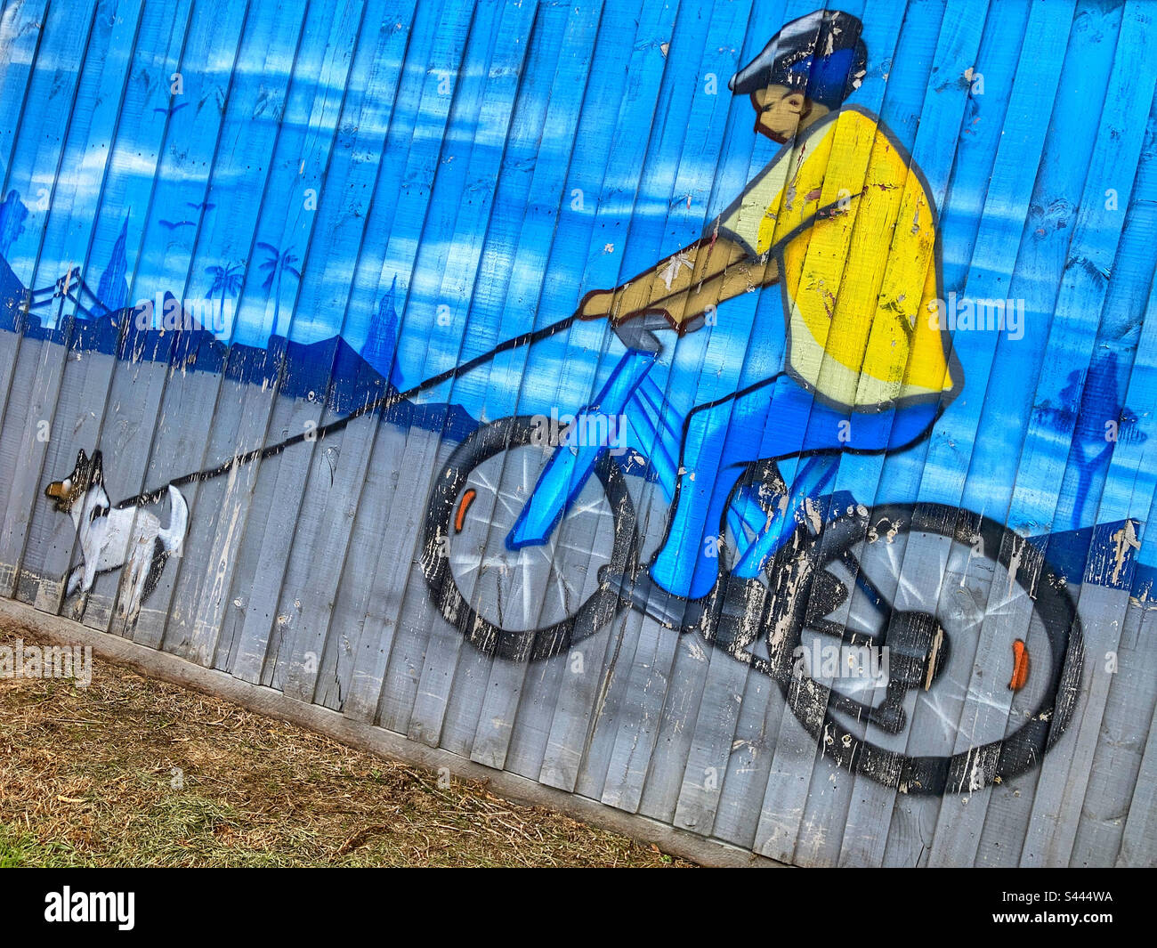 Graffiti of man walking his dog on a bicycle Old Wells Road Patterson Lakes Melbourne Australia - Smartphone Captured Stock Image