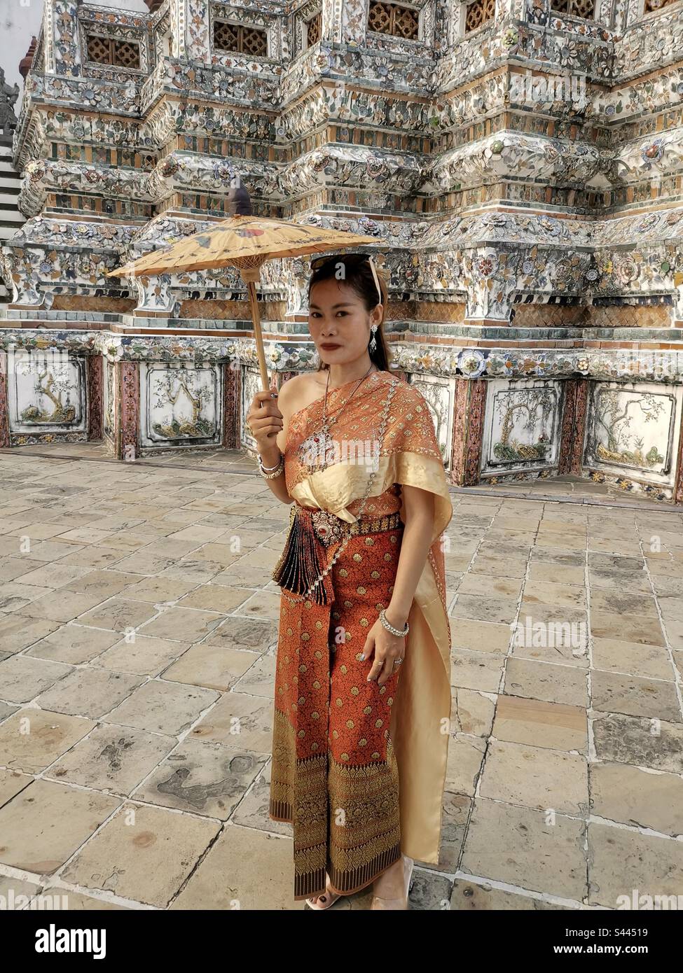A traditionally dressed Thai woman in Wat Arun, Bangkok, Thailand. - Smartphone Captured Stock Image