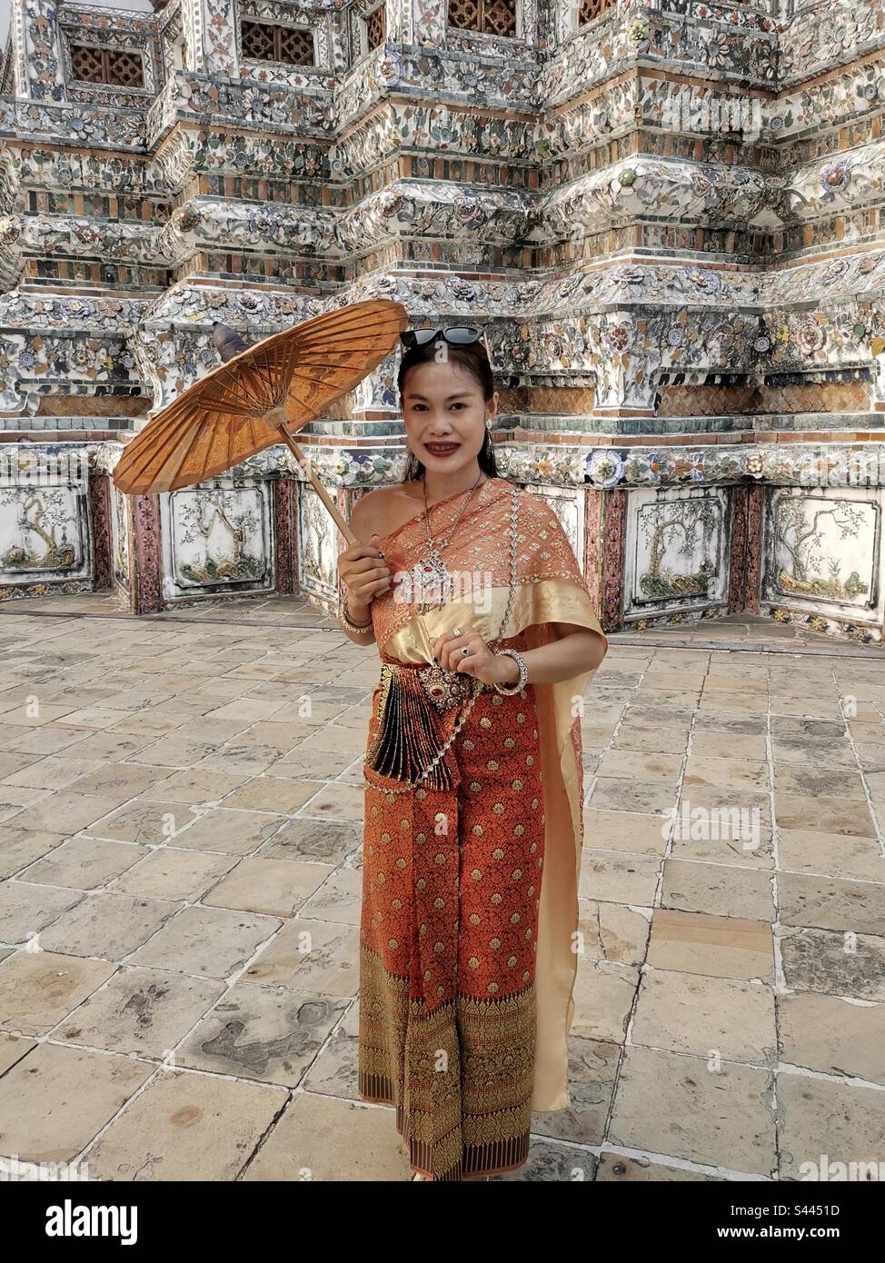 A traditionally dressed Thai woman in Wat Arun,Bangkok, Thailand. - Smartphone Captured Stock Image