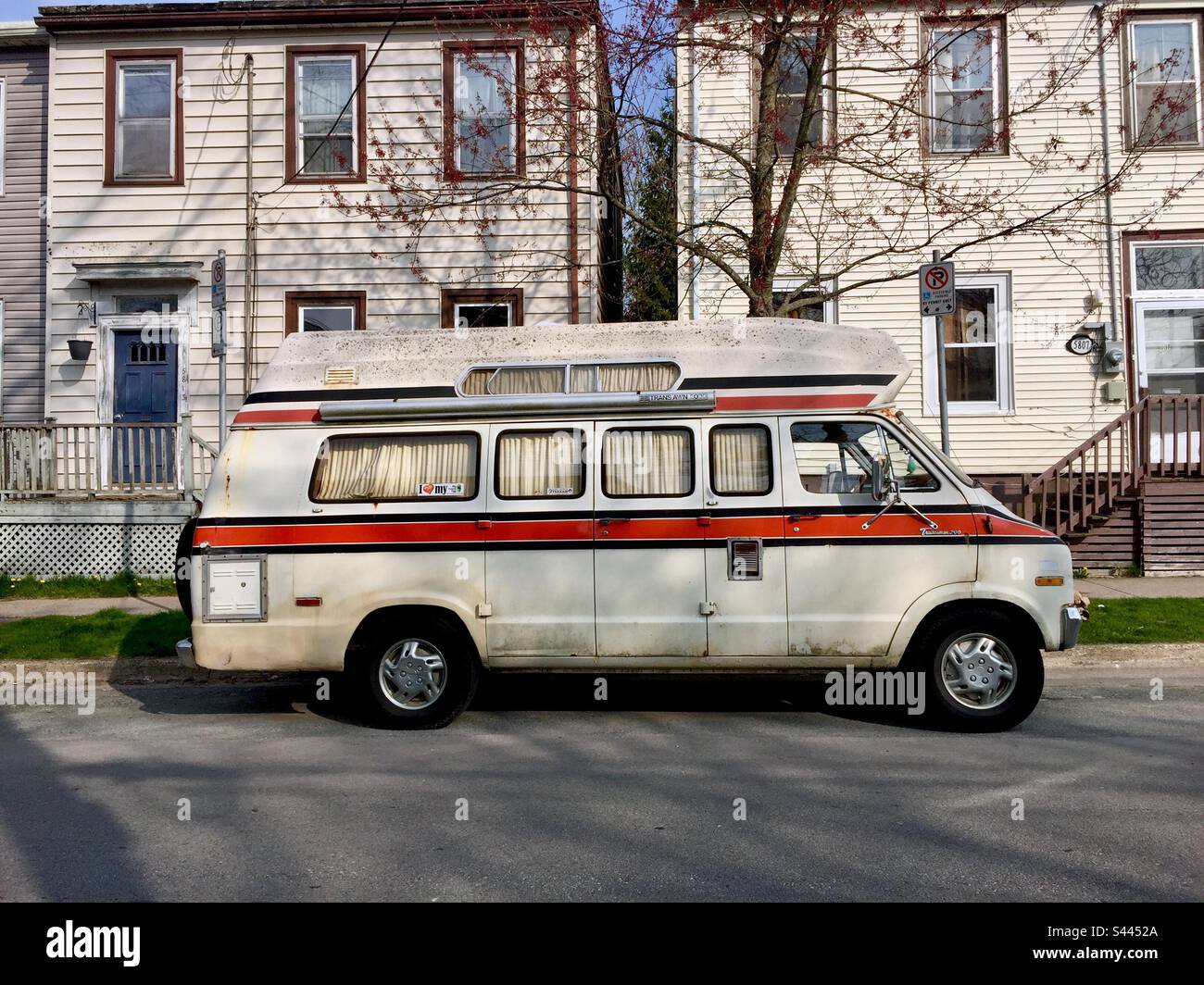 Urban nomad. An old camper van parked long term on a city street, Nova Scotia, Canada. Inspired by the movie, Nomadland. - Smartphone Captured Stock Image