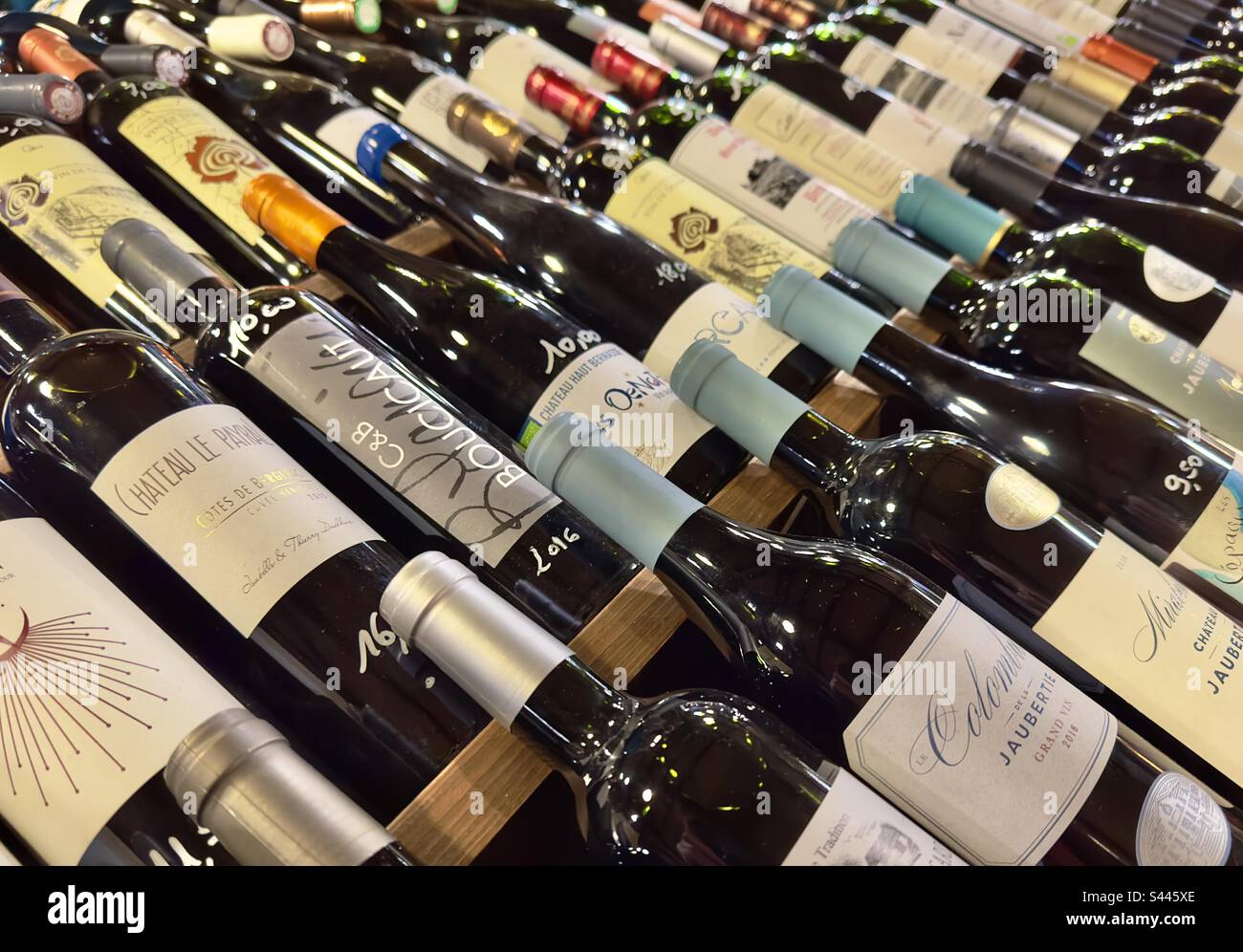 Rose of bottles of fine vintage wines in a French wine merchants warehouse. - Smartphone Captured Stock Image