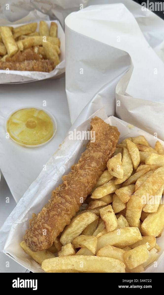 Battered sausage and chips with curry sauce lid Stock Photo Alamy