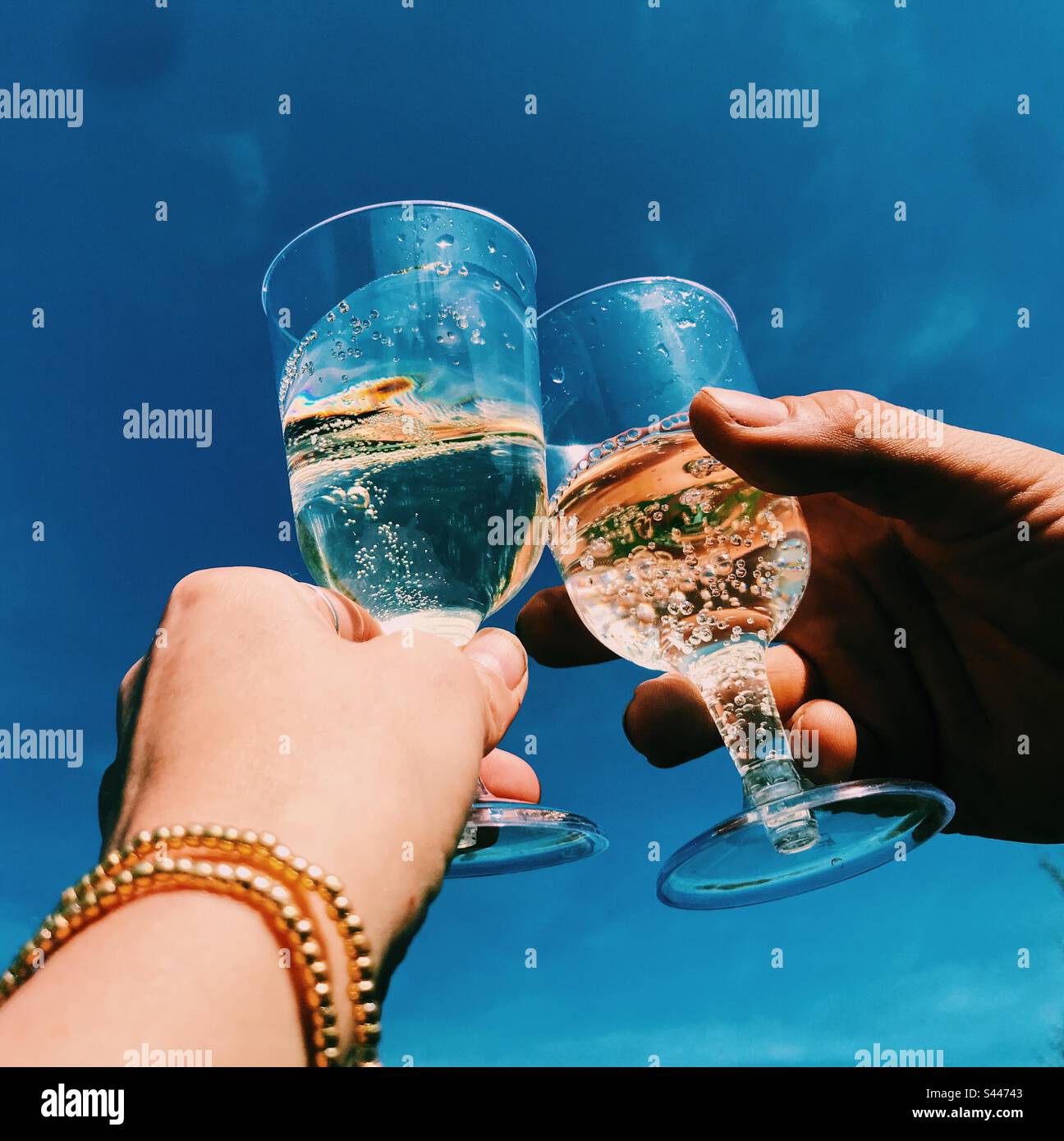 Cheers With Prosecco Glasses Against A Blue Sky Stock Photo Alamy