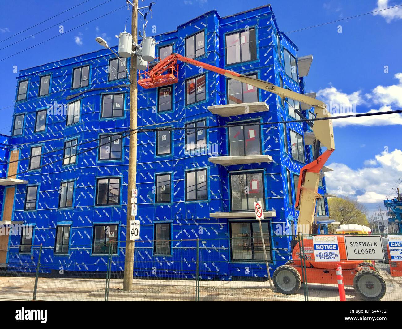 Modern construction. Clad in blue insulation. Exterior view. Extension lift. - Smartphone Captured Stock Image