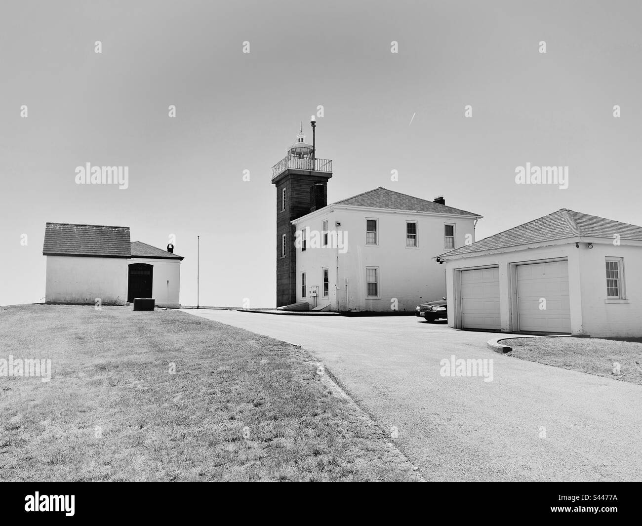 Watch Hill, Rhode Island, USA: View of Watch Hill Lighthouse with other buildings and road.  Black and white filter. Stock Photo