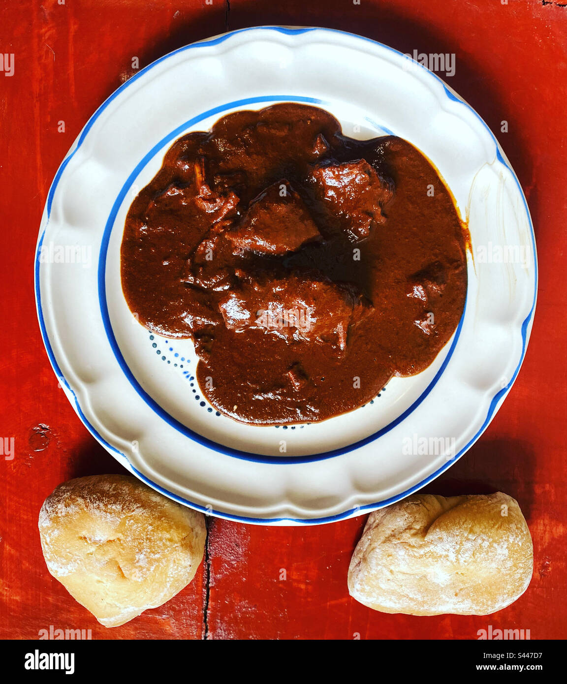 Chocolate homemade spicy mole with pork and bread in Queretaro, Mexico Stock Photo