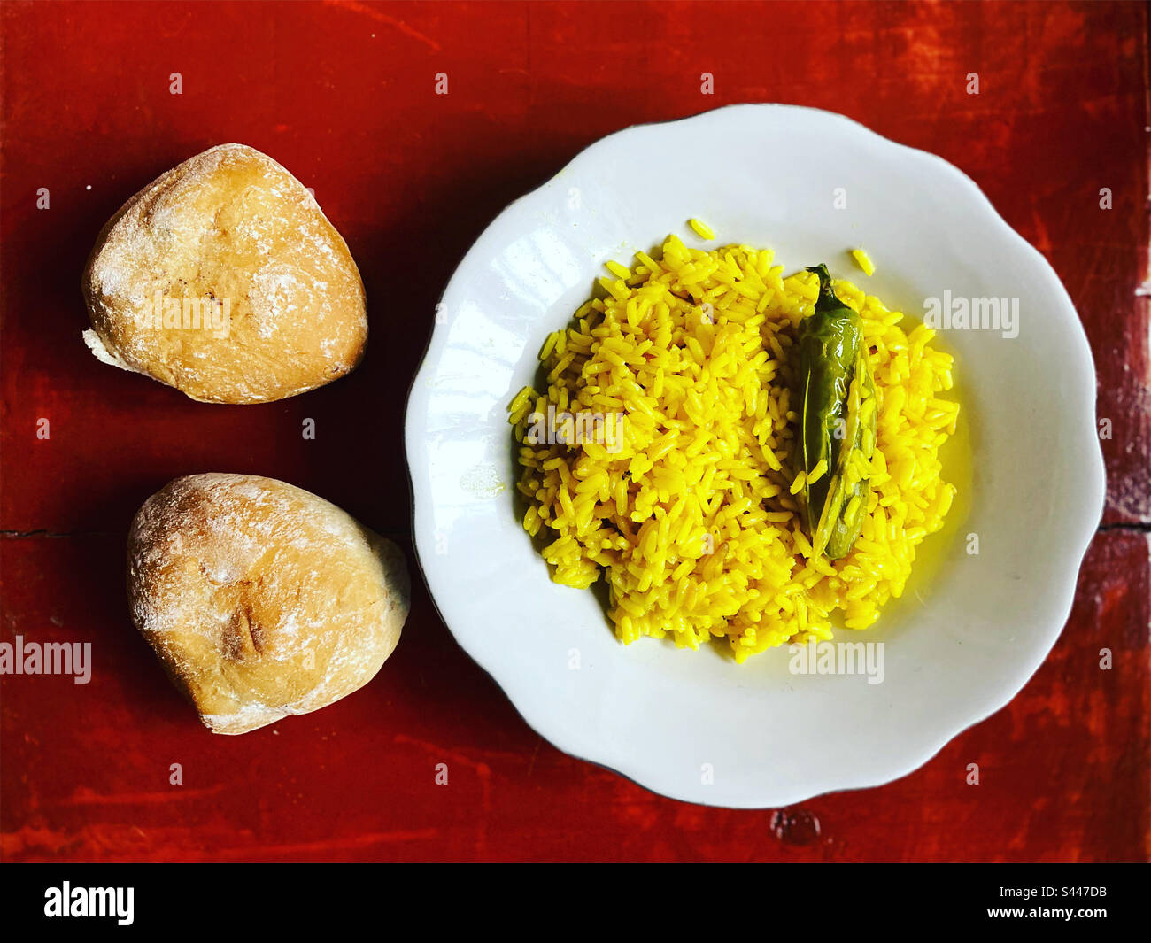 Yellow rice with a red hot chilli pepper and bread in Queretaro, Mexico Stock Photo