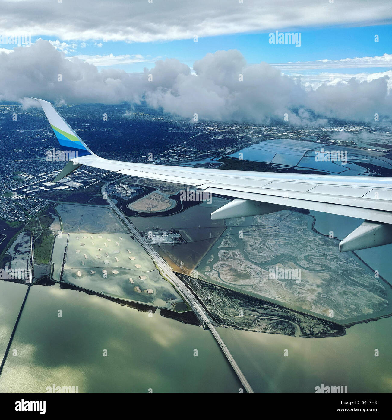 March, 2023, the wing of an Alaska Airlines airplane as it flies over Palo Alto, California, United States - Smartphone Captured Stock Image
