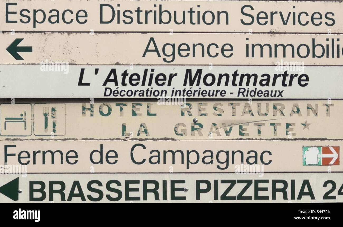 A jumble of direction signs in a town in the Dordogne in France - Smartphone Captured Stock Image