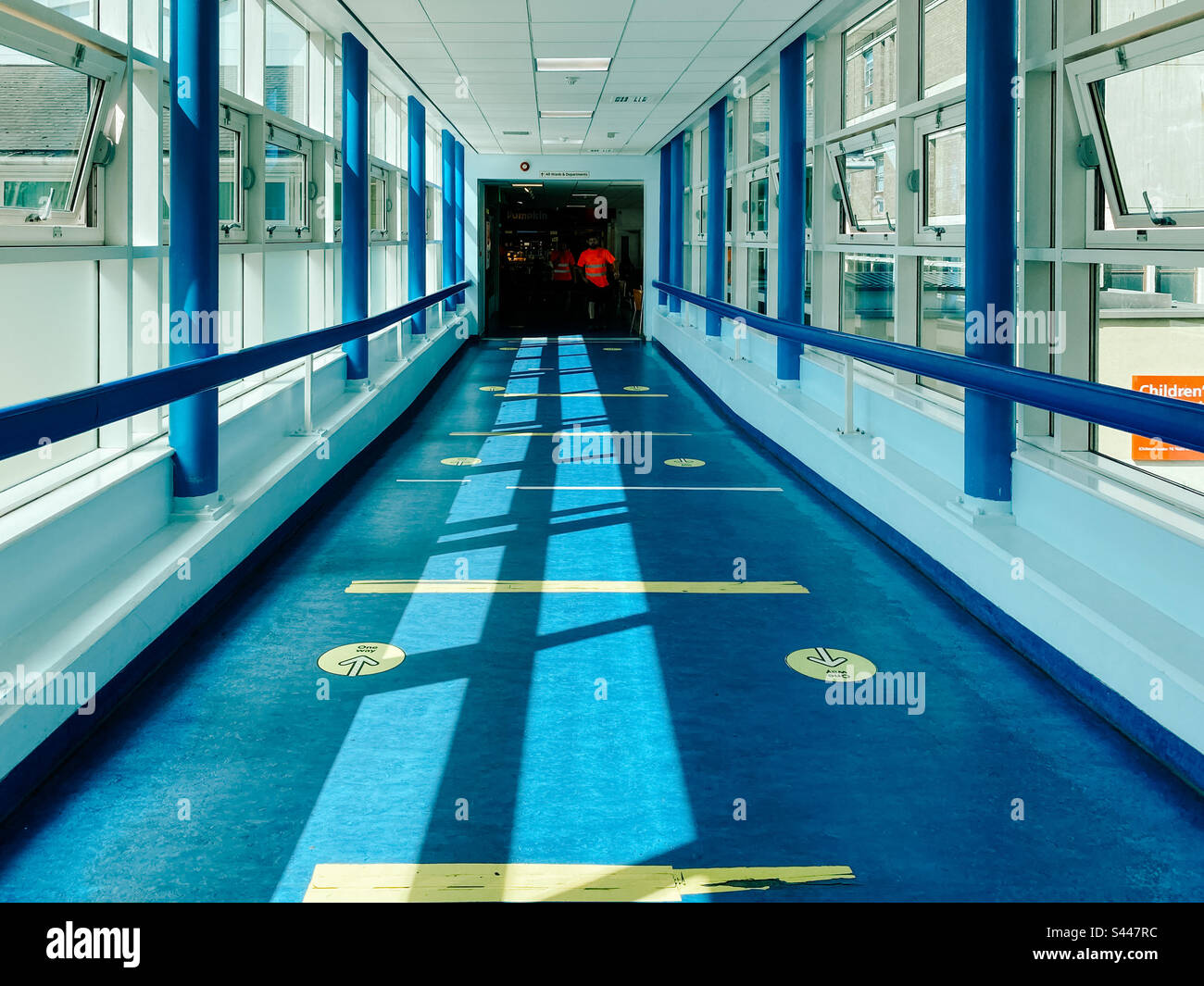 A corridor in a hospital with windows on each side giving a bright and airy feel - Smartphone Captured Stock Image