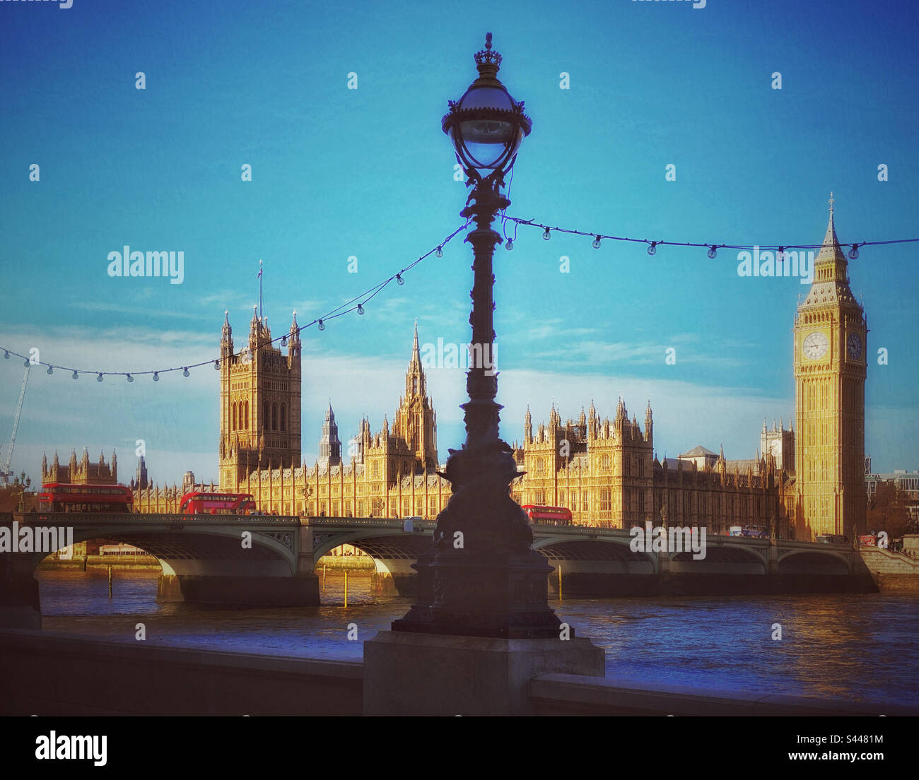 A creative & retro effect view of Westminster Bridge, Big Ben, The Elizabeth Tower & the Houses Of Parliament in London, England, UK. An iconic view, more so with 3 red London Buses as well! Photo©️CH - Smartphone Captured Stock Image