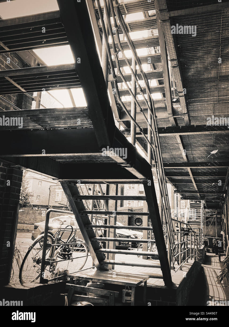 View from the underneath of an industrial metal staircase at a workplace in London - Smartphone Captured Stock Image