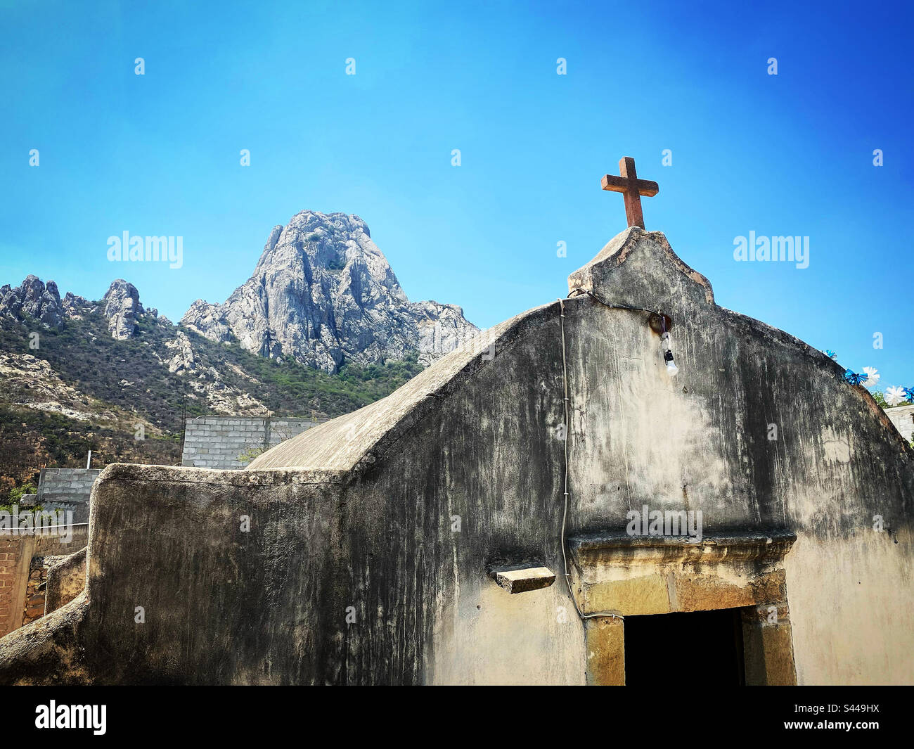 An old Capilla Oratoria or Praying Chappel with the Peña de Bernal in San Antonio de la Cal in Queretaro, Mexico - Smartphone Captured Stock Image