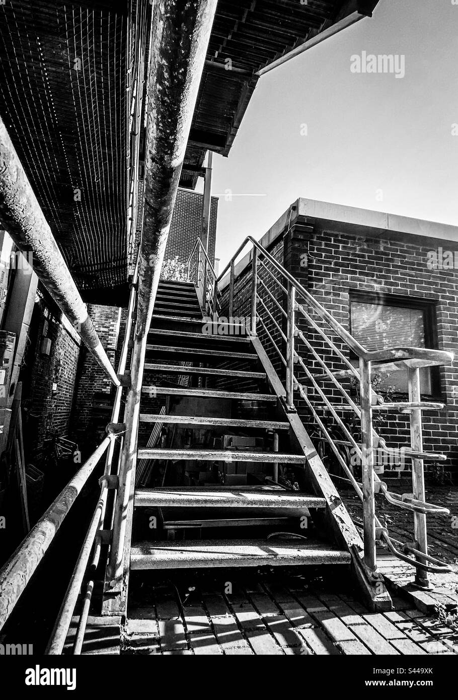 An industrial staircase in the sunlight at a Victorian warehouse building in London - Smartphone Captured Stock Image An industrial staircase in the sunlight at a Victorian warehouse building in London - Smartphone Captured Stock Image
