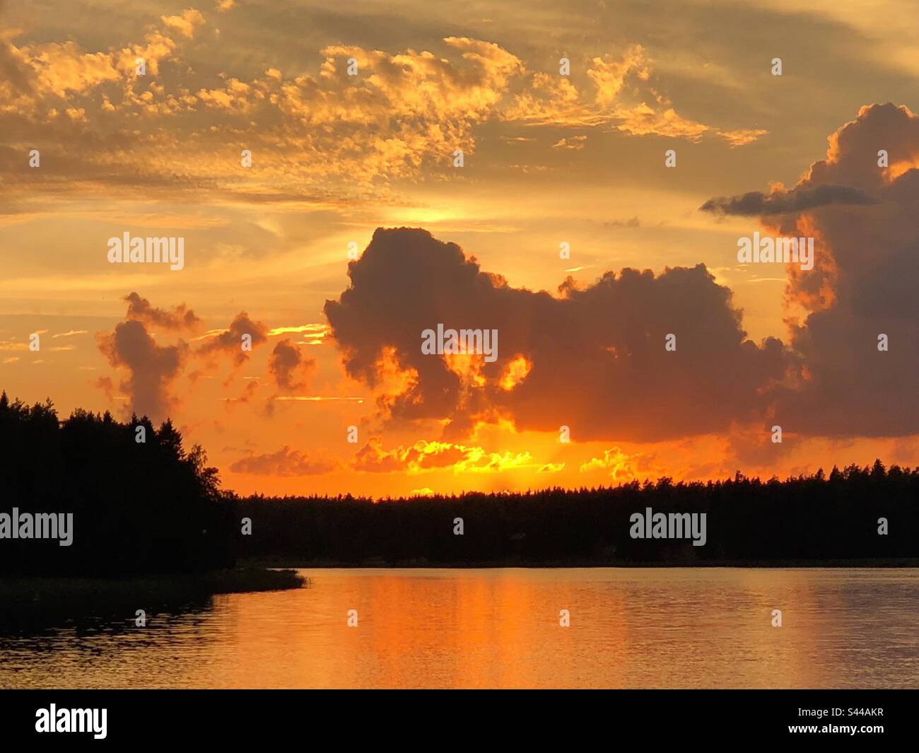Beautiful tranquil dramatic sunset landscape over the mirror smooth sea water surface - Smartphone Captured Stock Image