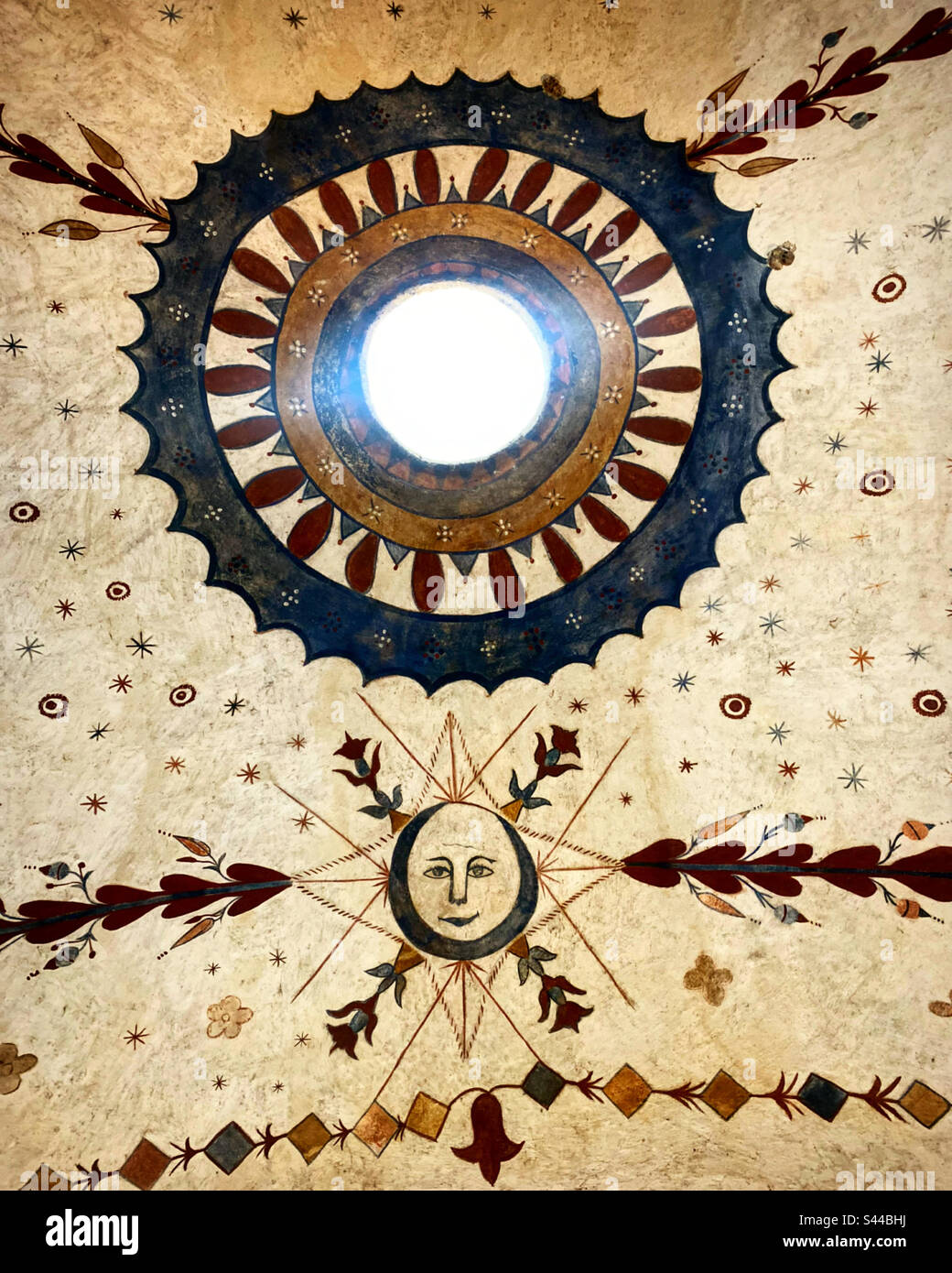 Sunlight shines on top of the dome decorated with a mural with a sun in the Capilla Oratoria Los Luna, San Antonio de la Cal, San Miguel Toliman, Queretaro, Mexico - Smartphone Captured Stock Image