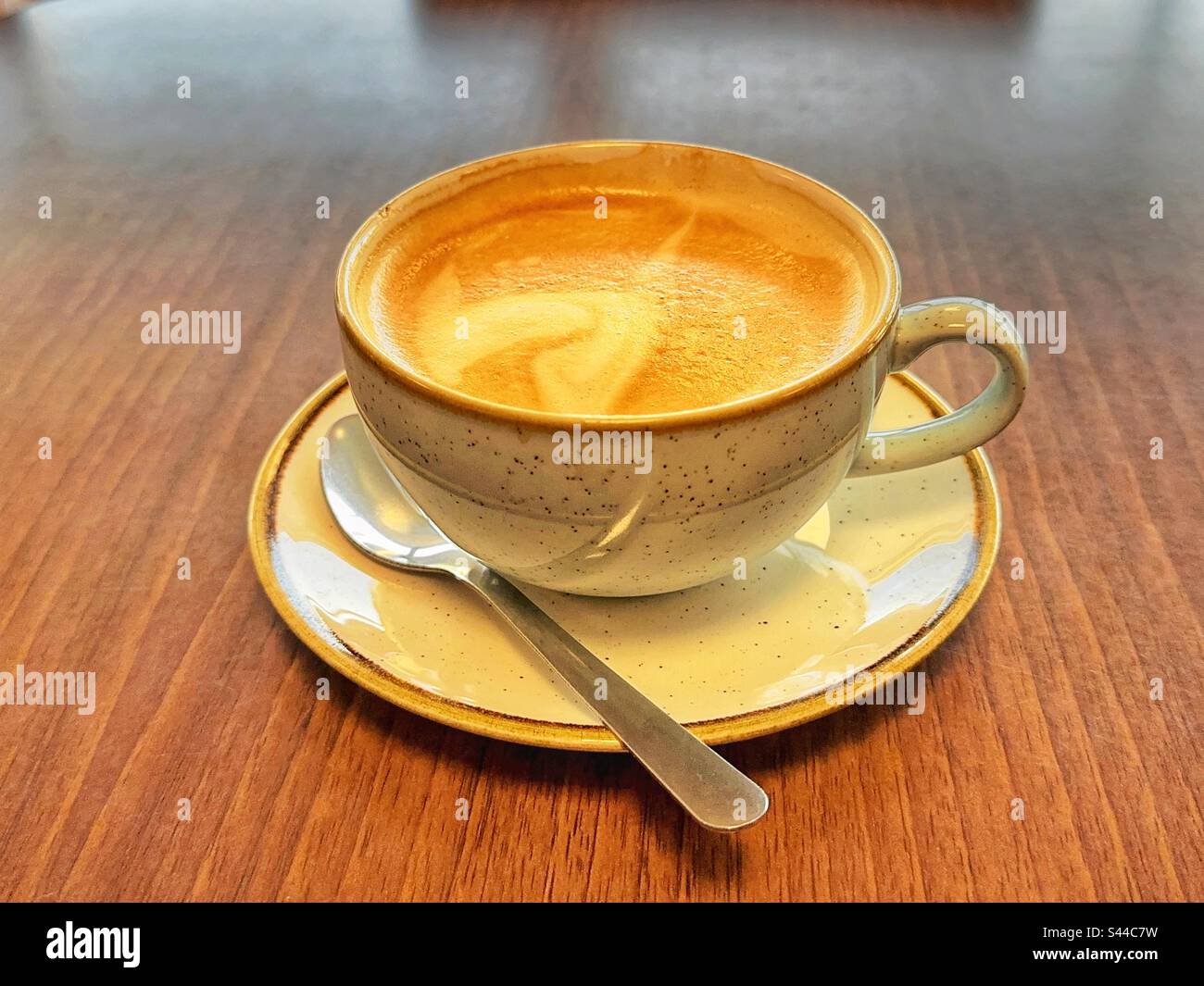 Close up view of a cup of hot frothy coffee. No people. Stock Photo