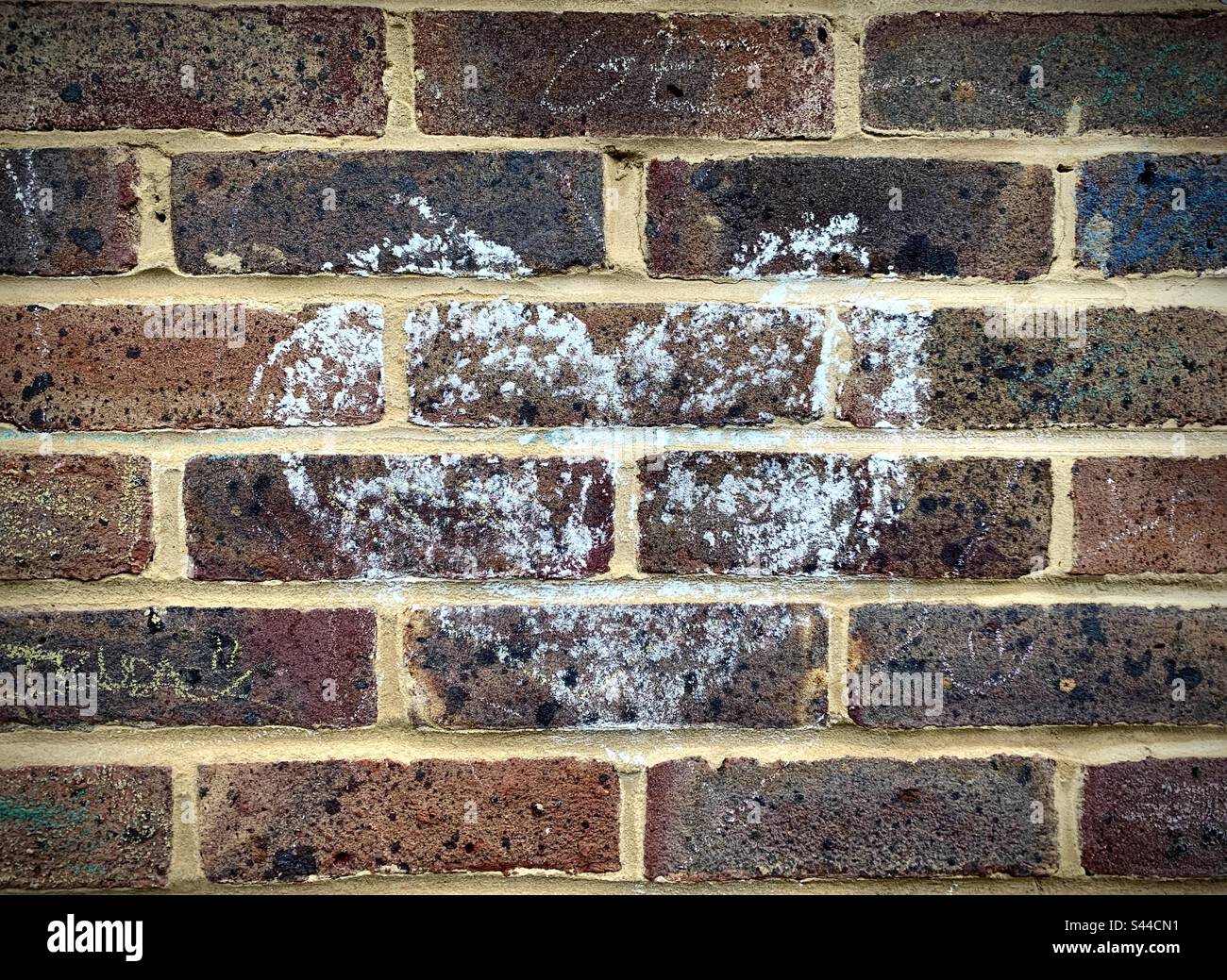 A drawing of a white chalk heart on a brick wall Stock Photo Alamy