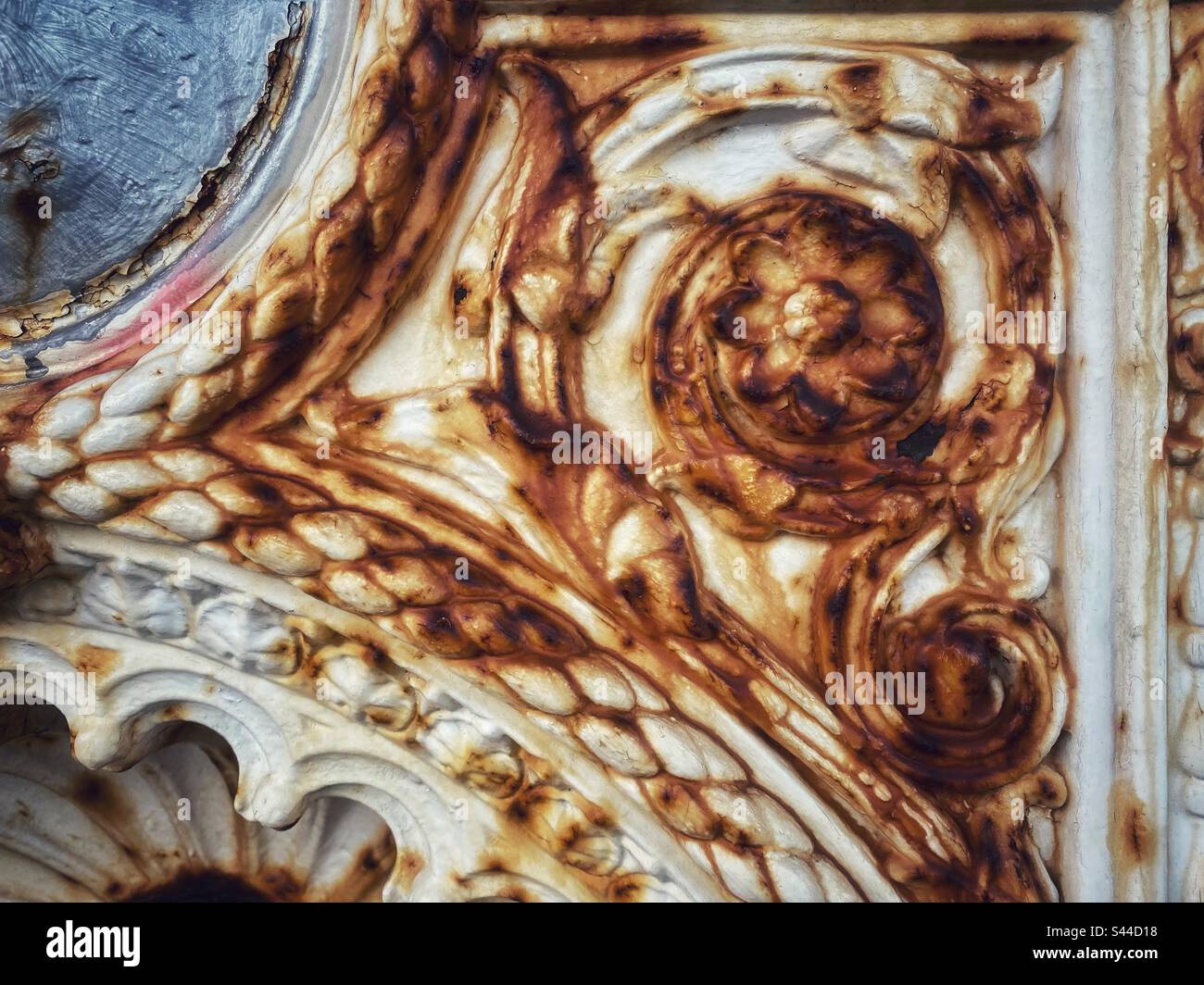 A photograph of old orange white metalwork with rust damage - Smartphone Captured Stock Image