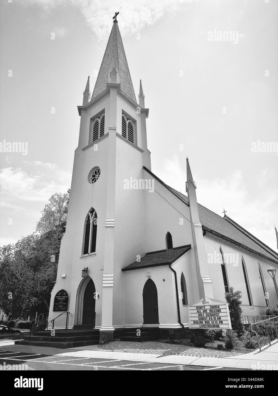 Trinity Church Episcopal in Branford, Connecticut, USA. Episcopalian church with white building and tall steeple. Black and white filter. - Smartphone Captured Stock Image