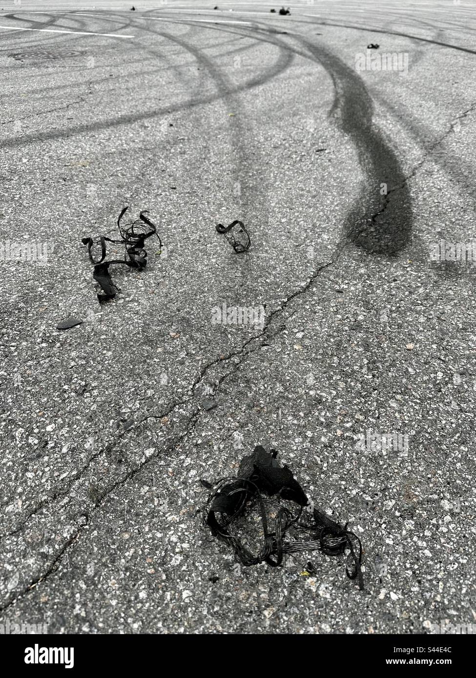 Car tire marks and pieces on a parking lot Stock Photo