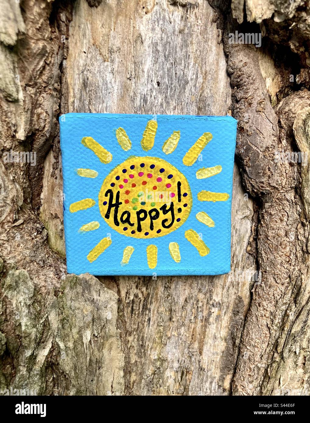 I found this little painting hanging from a tree in the park. - Smartphone Captured Stock Image