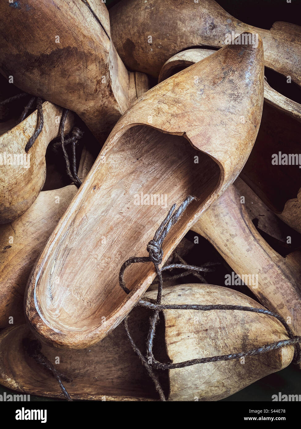 A box of wooden sandals held in pairs by string - Smartphone Captured Stock Image
