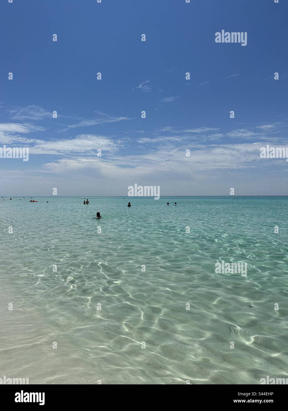 May 22, 2023 Destin, Florida USA People enjoying swimming in the crystal clear water of the Gulf of Mexico - Smartphone Captured Stock Image