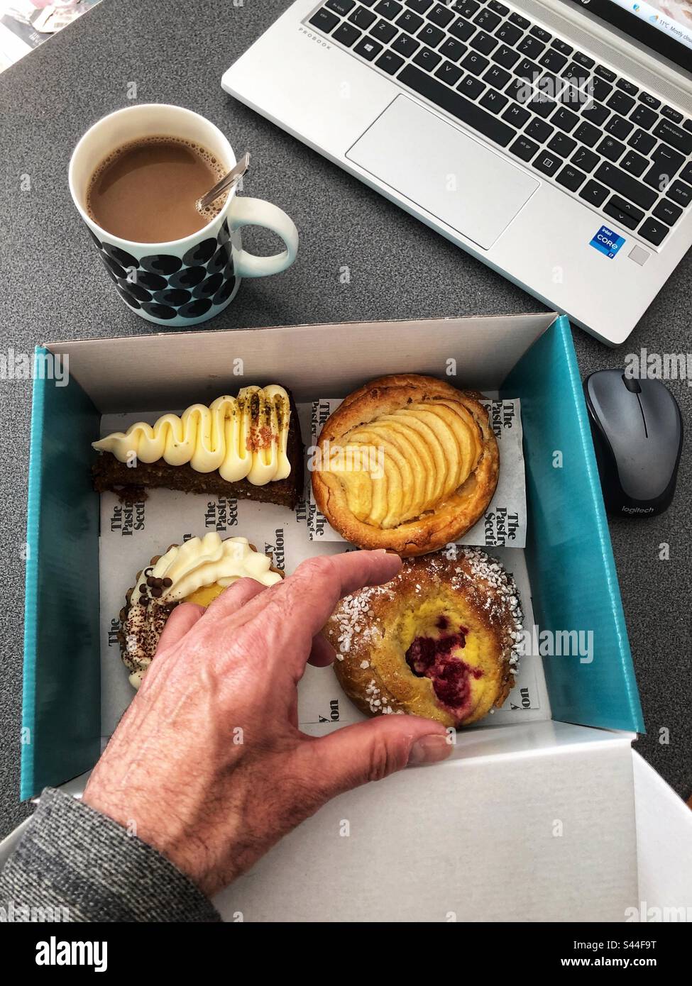 Temptation Choice of speciality cakes, Coffee and cake break at work, working from home office wfh - Smartphone Captured Stock Image