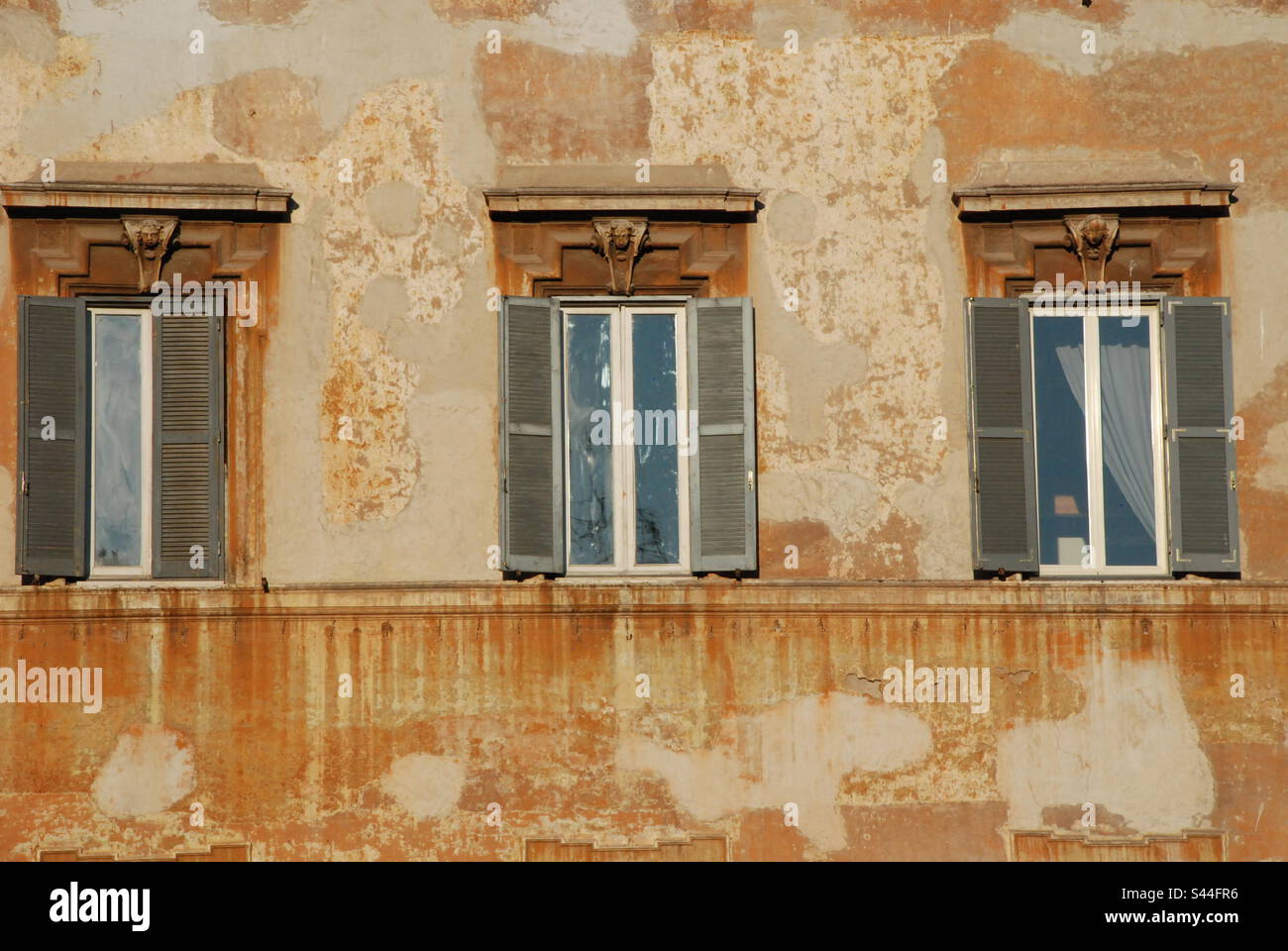 Three blue shutters on an old world Italian stucco wall Stock Photo Alamy