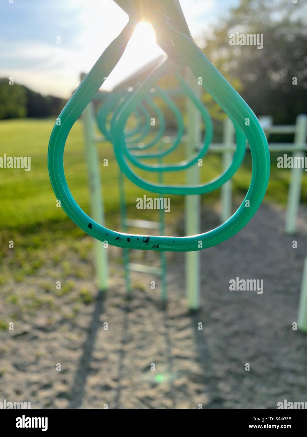 Teardrop monkey bar rings at playground Stock Photo Alamy